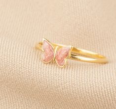 Discover the whimsical charm and luxurious craftsmanship of our 14K Gold Butterfly Ring. This enchanting piece captures the delicate beauty of butterflies, offered in a palette of blue, pink, or white enamel, and is meticulously handcrafted in your choice of gold, rose gold, or white gold. Ideal for adding a touch of nature-inspired elegance to any ensemble, it's a stunning and versatile addition to any jewelry collection. Key Features: Elegant Aesthetics: The ring features a detailed butterfly Dainty Rose Gold Butterfly Open Ring, Elegant Adjustable Rose Gold Butterfly Ring, Elegant Pink Butterfly Ring, 14k Gold Butterfly-shaped Rings As Gift, Adjustable Pink Butterfly Jewelry, Gold Butterfly Ring, Butterfly Ring, Gold Butterfly, White Enamel