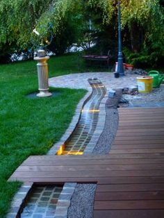 a wooden walkway next to a lush green park