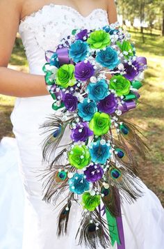 a wedding bouquet with peacock feathers and flowers on the bottom is featured in an instagram