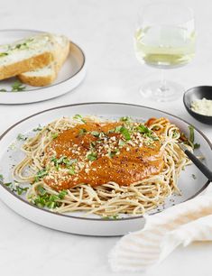 a plate of spaghetti with sauce and parmesan cheese