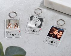 three personalized key chains with two pictures on the front and one in the back