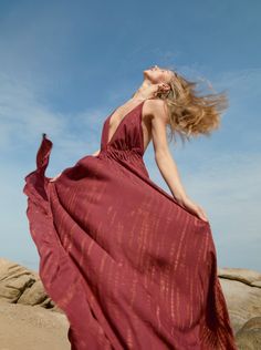 Embrace dreamy vacation vibes any time of the year with this tie-dye halter neck maxi dress in burgundy. Designed for long, carefree days under the sun, the Luna Maxi Dress strikes the balance between stylish and comfortable. Featuring a jaw-dropping deep V-neck and a head-turning open back, this maxi dress gives you a slender, elongated silhouette that you’ll love. The almost fluidic softness of the fabric and the delicate flow of the full-length hemline give you an effortlessly graceful look.W Summer Sleeveless Burgundy Maxi Dress, Red Bohemian Halter Neck Dress, Sleeveless Burgundy Maxi Dress For Summer, Bohemian Red Halter Dress For Summer, Red Bohemian Halter Dress For Summer, Vacation Festival Dresses With Halter Neck, Burgundy Beach Dress For Summer, Flowy Burgundy Dresses For Summer, Burgundy Bohemian Summer Dress