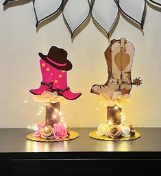 two cakes decorated with cowboy boots and lights