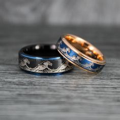 two gold and blue wedding bands with horses on them