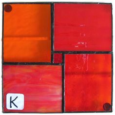 an orange and red tile with the letter k on it