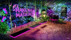 an artistic display with neon lights and tropical plants on the wall, in front of purple lighting