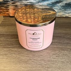 a pink candle sitting on top of a wooden table