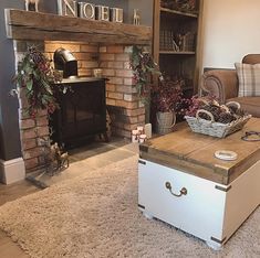 a living room filled with furniture and a fire place in front of a brick fireplace