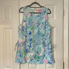 Nwot Lilly Pulitzer Tank Top Blouse. Blue, Green, And Pink Floral And Animal Print. Fabric Tie Accent At Waist. Zipper At Back Of Neckline. Never Worn, Zipper Pull Still In Protective Plastic. No Damage. Smoke Free Environment. Light Blue Sleeveless Blouse For Vacation, Animal Print Fabric, Tank Top Blouse, Green And Pink, Print Fabric, Lilly Pulitzer, Pink Floral, Animal Print, Blue Green