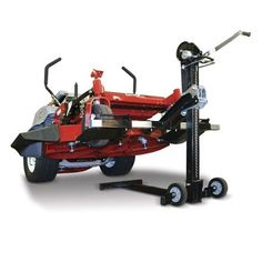 a red lawn mower sitting on top of a black stand next to a white background