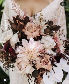 a woman holding a bouquet of flowers in her hands