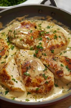 some chicken with sauce and parsley in a pan