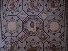 the ceiling is decorated with pictures of women and men in circles on it's surface