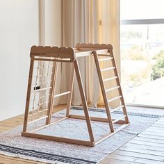 two wooden ladders sitting on top of a rug in front of a sliding glass door