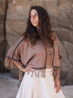 Boho Fringe Poncho made of strong and light natural cotton. Perfect for hot summer days, parties, festivals or ceremonies.  You can find the Layered Boho Maxi Skirt here: https://www.etsy.com/listing/1549857532/ SIZE: One size - very loose fit  MEASURES Hip width: 37 inch Sleeve length: 16 inch  (not including frayes) Front length: 19 inch (not including frayes) Back length: 26 inch (not including frayes) COLOR Rose Brown ☼ NATURAL FABRICS Most of our clothes are made with handwoven fabrics and Earthy Tops, Earthy Clothing, Grass Dance Outfits, Block Print Top, Natural Clothes, Organic Detergent, Ceremonial Clothing, Boho Maxi Skirt, Fringe Poncho