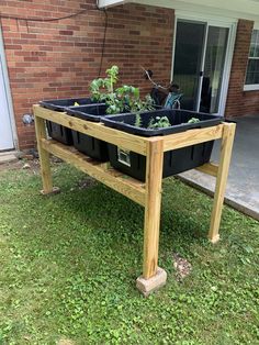 an elevated garden bed with plants growing in it