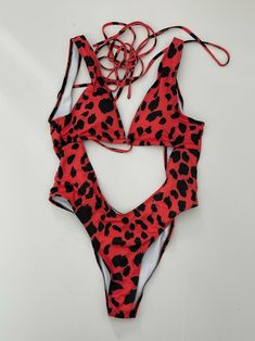 Red Halter Neck Swimwear For Summer, Red Backless Swimwear For Summer, Trendy Sleeveless One-piece For Vacation, Trendy Sleeveless One Piece For Vacation, Trendy Red Swimwear For Summer, Trendy Red Swimwear For The Pool, Beach Season Party Printed One-pieces, Red Lined Bodysuit For Pool, Red Trendy Swimwear For Vacation