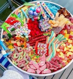 a large bowl filled with lots of candy and candies on top of a table