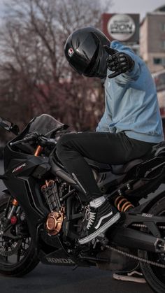 a man riding on the back of a black motorcycle