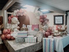 a table with many presents and balloons on it