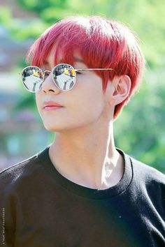 a young man with red hair and mirrored sunglasses