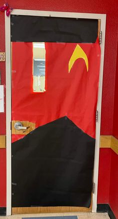 a red door with a black and yellow flag on it