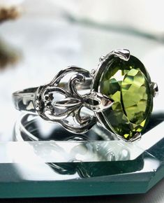 Natural Peridot Ring  Small Fat Oval Design #111 (MADE TO ORDER)  This is a brand new stunning Gothic inspired sterling silver filigree ring. The flawless oval-cut 3.3ctwt natural peridot is 11mm (7/16th of an inch) by 9mm (just shy of 3/8" inch) in dimension... The inside of the band is marked 925 for sterling silver. This natural peridot has superb color and clarity. Notice the beautiful filigree swirl like the craftsmanship of the silver setting. This is an exquisite rendition of a Gothic des Gothic Design, Peridot Ring, Sterling Silver Filigree, Filigree Ring, Engraved Items, Silver Filigree, Make Design, Ring Sterling Silver, Solitaire Ring