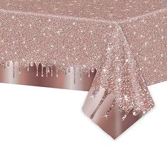 a pink table cloth with silver stars and sparkles on the top, in front of a white background