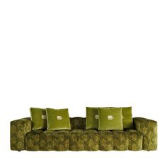 a green couch with four pillows on it