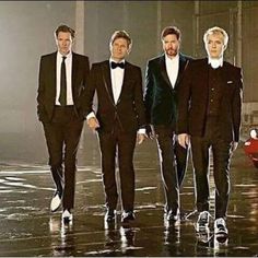 three men in tuxedos standing next to each other