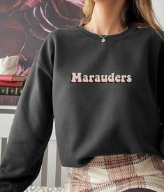 Get ready to show your love for the iconic characters - Sirius Black, Remus Lupin, James Potter, Regulus Black, and Lily Potter - with this must-have vintage dark academia inspiredsweatshirt! Made from soft, high-quality materials, this sweatshirt is both comfortable and stylish. Whether you're lounging at home or out and about, this Marauders sweatshirt will keep you cozy and show your love for these legendary characters. Its stylish design makes it the perfect accessory for fans who want to make a statement. So why wait? Order your Marauders sweatshirt today and show your support for Sirius Black, Remus Lupin, James Potter, Regulus Black,  Peter pettigrew . Stay cozy and stylish as you demonstrate your love for the Marauders!Marauders all the young dudes retro vintage 70s unisex sweatshi Retro Black Sweatshirt For Fan Merchandise, Retro Black Fan Merchandise Sweatshirt, Retro Black Sweatshirt With Letter Print, Trendy Crew Neck Sweatshirt For Fan Merchandise, Retro Fall Fan Merchandise Sweatshirt, Retro Black Sweatshirt For College, Retro Crew Neck Sweatshirt For Fan Merchandise, Retro Crew Neck Hoodie With Ribbed Cuffs, Crewneck Aesthetic