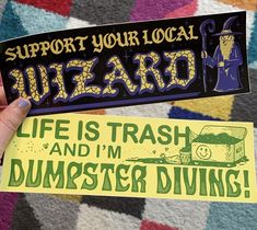 someone holding up a sticker that says, support your local wizard life is trash and i'm dumpster diving