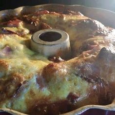 a casserole dish with meat and cheese in it on top of an oven rack