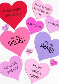 several heart shaped magnets with words on them