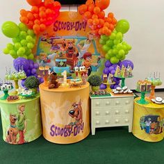 an image of a birthday party setting with balloons and decorations on the table for scooby's