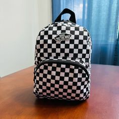 Mini Backpack With Classic Checkerboard Design Front Zippered Pocket Approx. Size: 8” X 10” X 5” Trendy Vans Travel Bag, Vans Backpack For School, Vans Backpack For Everyday And Back To School, Casual Vans Backpack For Daily Use, Vans Rectangular Bag For Daily Use, Vans Rectangular Bag For Everyday, Vans Standard Backpack For Daily Use, Vans Standard Backpack For Everyday, Vans Everyday Standard Backpack