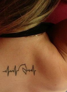 a woman's neck with a heartbeat tattoo on her left side ribcage