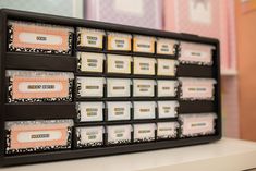 a black tray with many different types of labels on it and other items in the bins