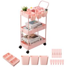 a pink cart with lots of books and cups on it next to some other items