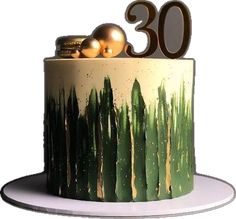 a green and gold cake with the number 30 on top