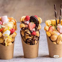 three cups filled with different types of desserts on top of each other and topped with strawberries