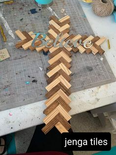 a cross made out of wood sitting on top of a table