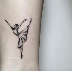 a black and white ballerina tattoo on the ankle