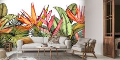 the living room is decorated with tropical wallpaper