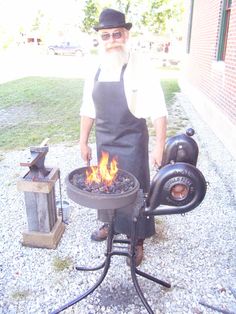 an old man standing in front of a grill with flames coming out of the top