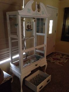 a white china cabinet sitting on top of a carpeted floor