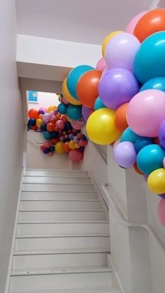 there is a bunch of balloons in the air on the stairs to the second floor