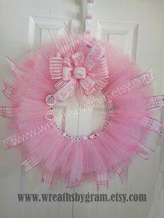 a pink tulle wreath hanging on the front door