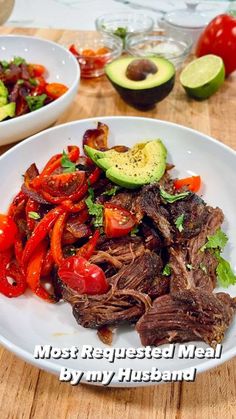 a white plate topped with meat and veggies on top of a wooden table