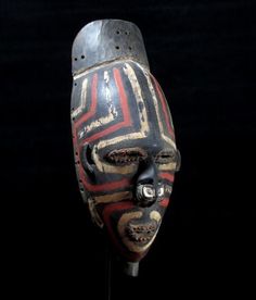 an african mask is displayed on a black background